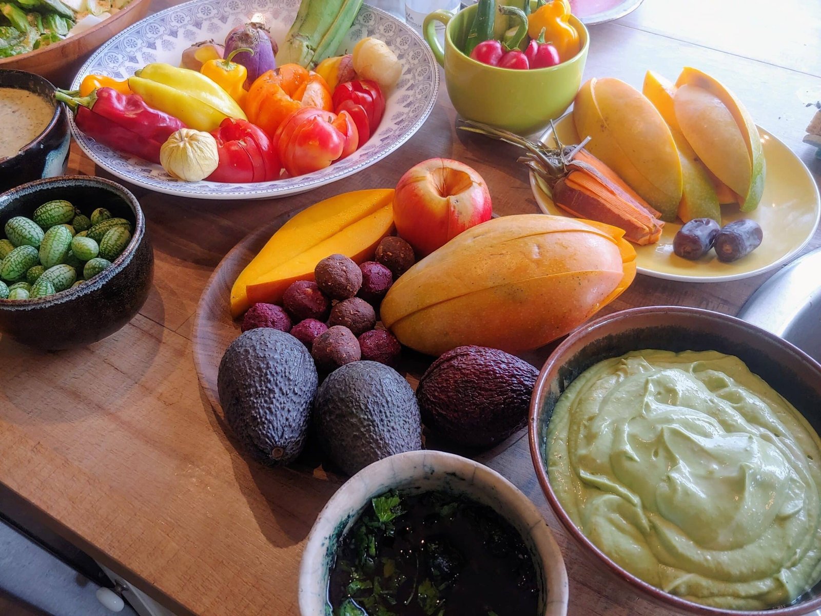 a table with bowls of fruit and vegetables